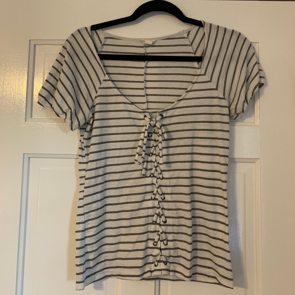 Cute white with black stripes lace up shirt.
